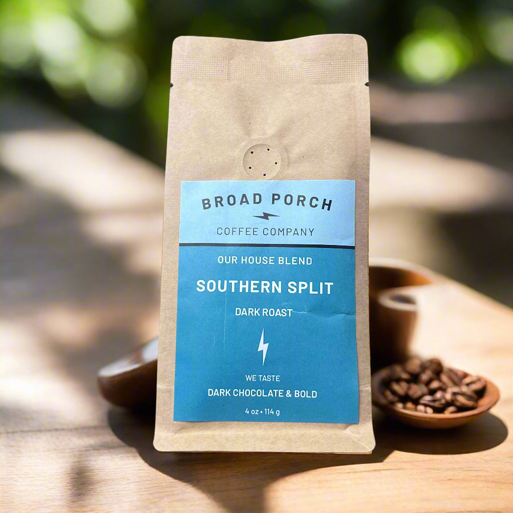 Coffee bag from Broad Porch Coffee Company on a wooden surface with blurred greenery in the background