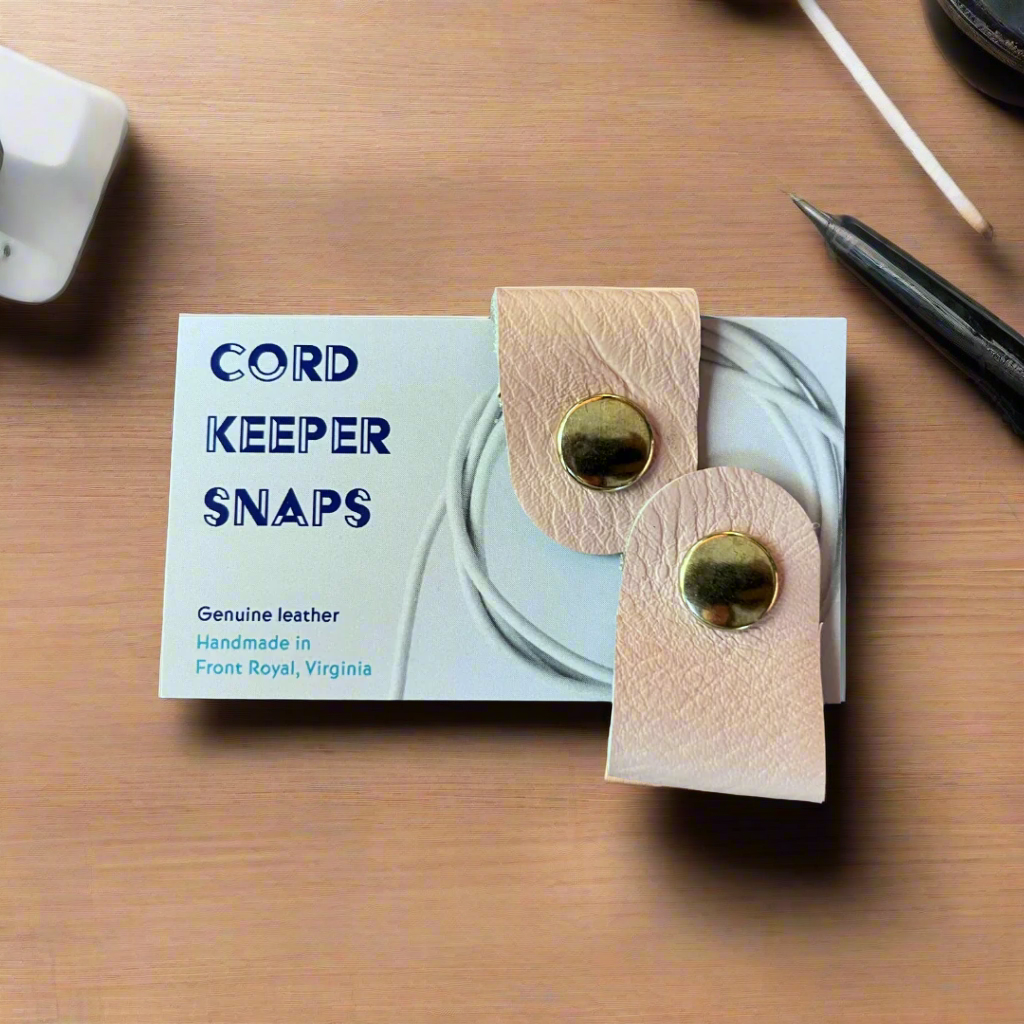 Leather cord keeper snaps with packaging on a wooden surface