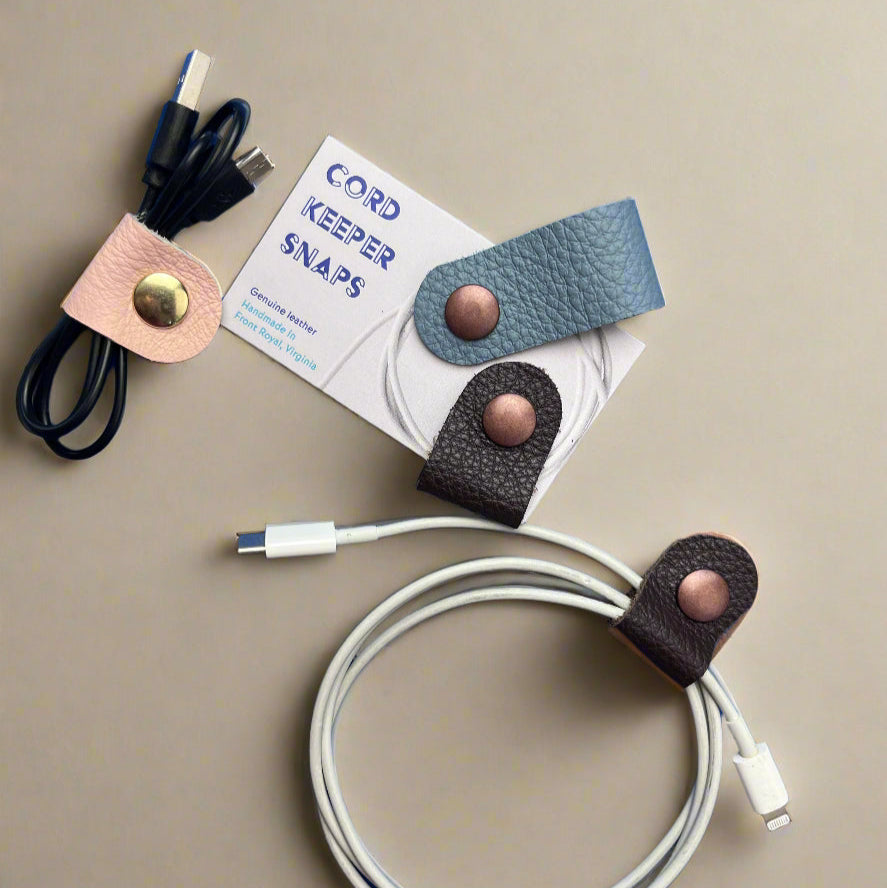 Cord Keeper Snaps with a USB cable on a blue background